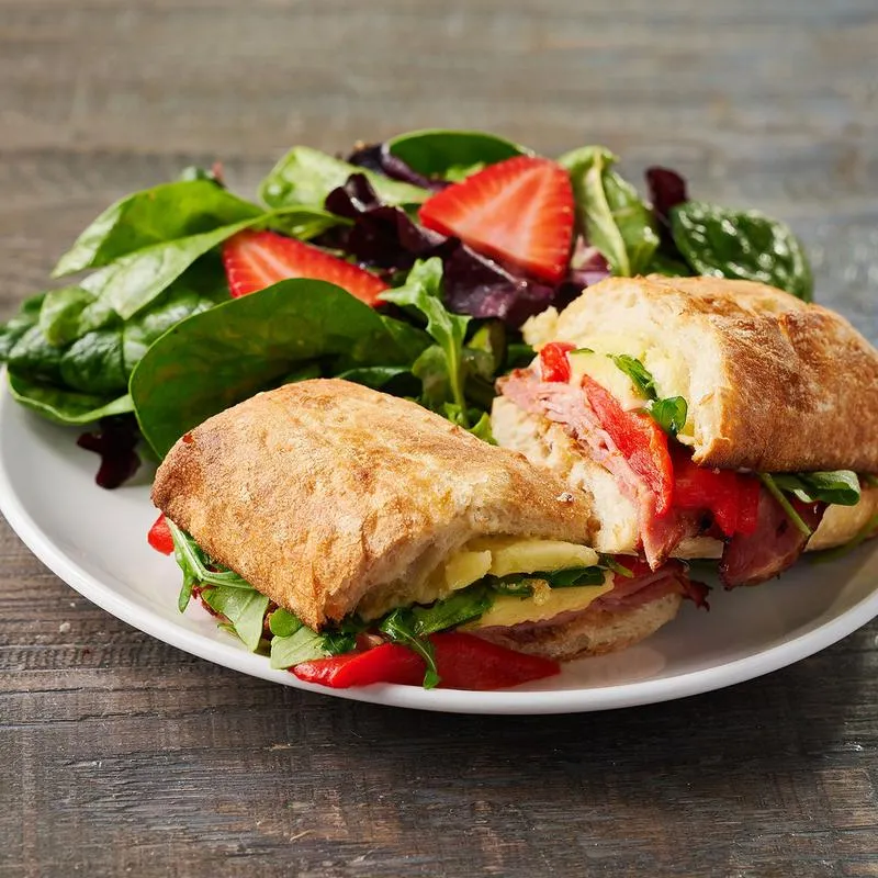 Two sandwiches and salad on the side