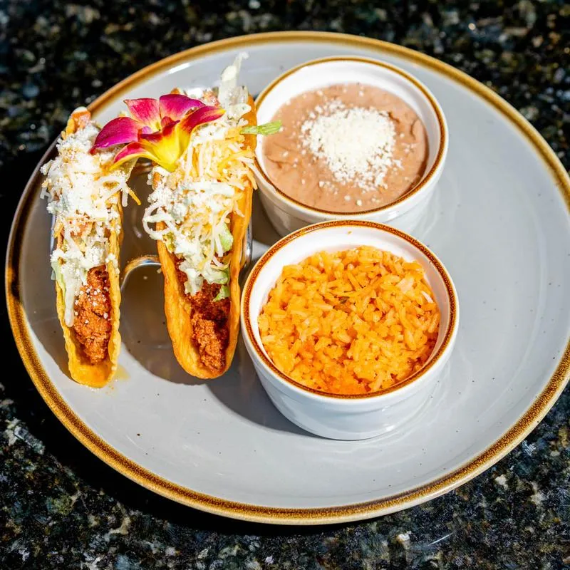 Ground beef chalupas, served with rice and beans.
