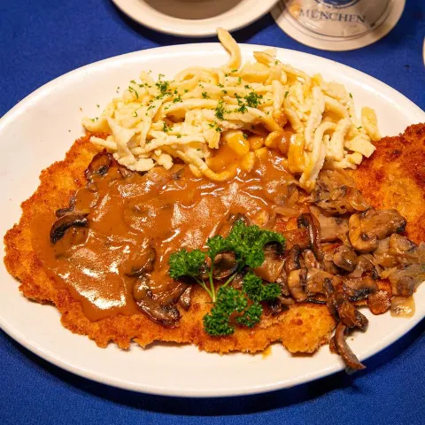 Breaded pork schnitzel, with mushroom and onion gravy, and noodles.
