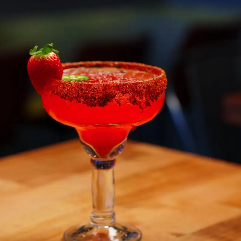 Strawberry Jalapeño Margarita garnished with a strawberry and slice of jalapeno.