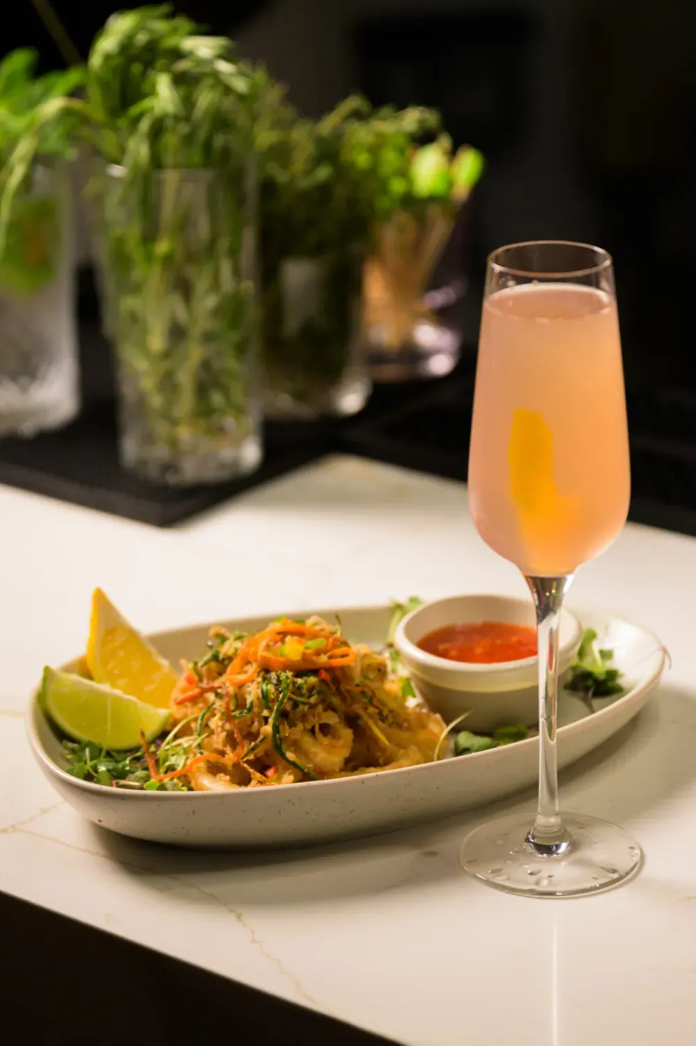 Plated dinner with cocktail on a restaurant counter