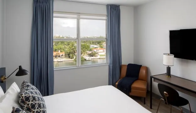 A Bedroom With A Large Window