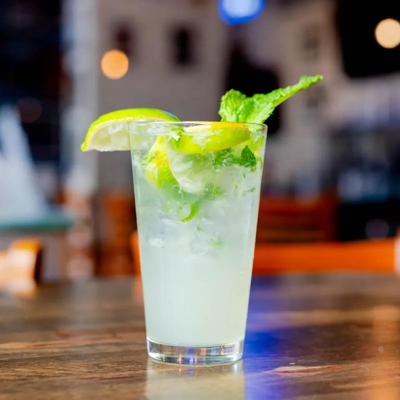Mojito cocktail with mint and lime garnish.