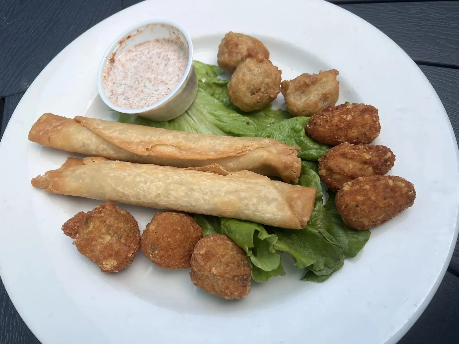 Tex-Mex Sampler, Hatch Chili Chicken street taco, Guacamole Bites, Battered Elote Corn Bites, Queso Loaded tots, and a side of Cajun Ranch