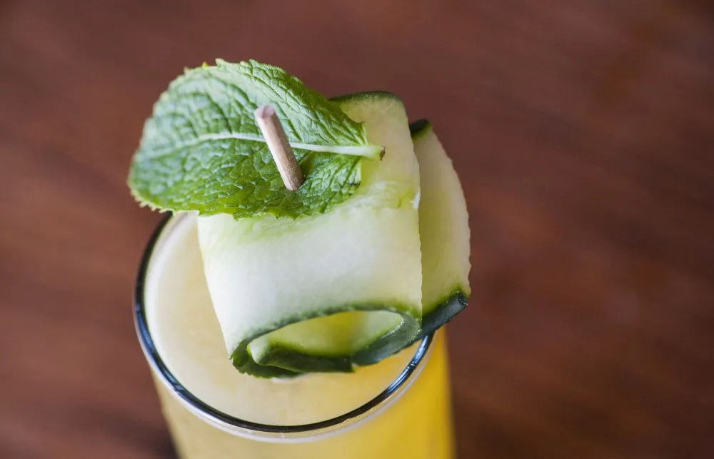 Mint and cucumber toppings on Reviver cocktail from bartaco
