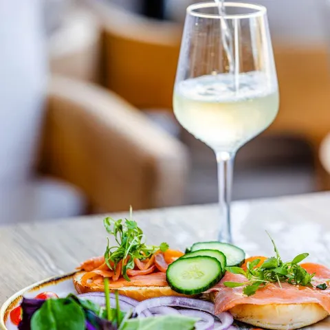 A served salad with a drink.