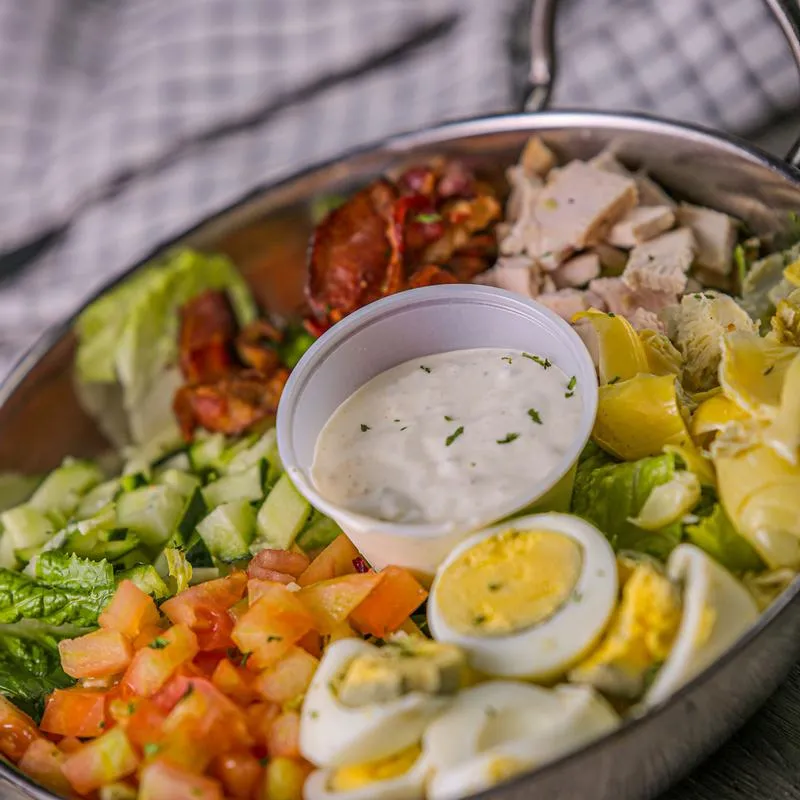 Mixed salad, boiled eggs and dip on the side.