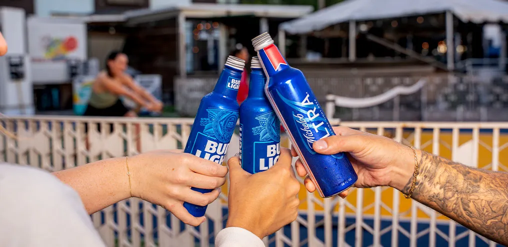 Friends toasting Bud Light and Michelob Ultra beers on the outdoor patio at Ferg's Sports Bar St Pete