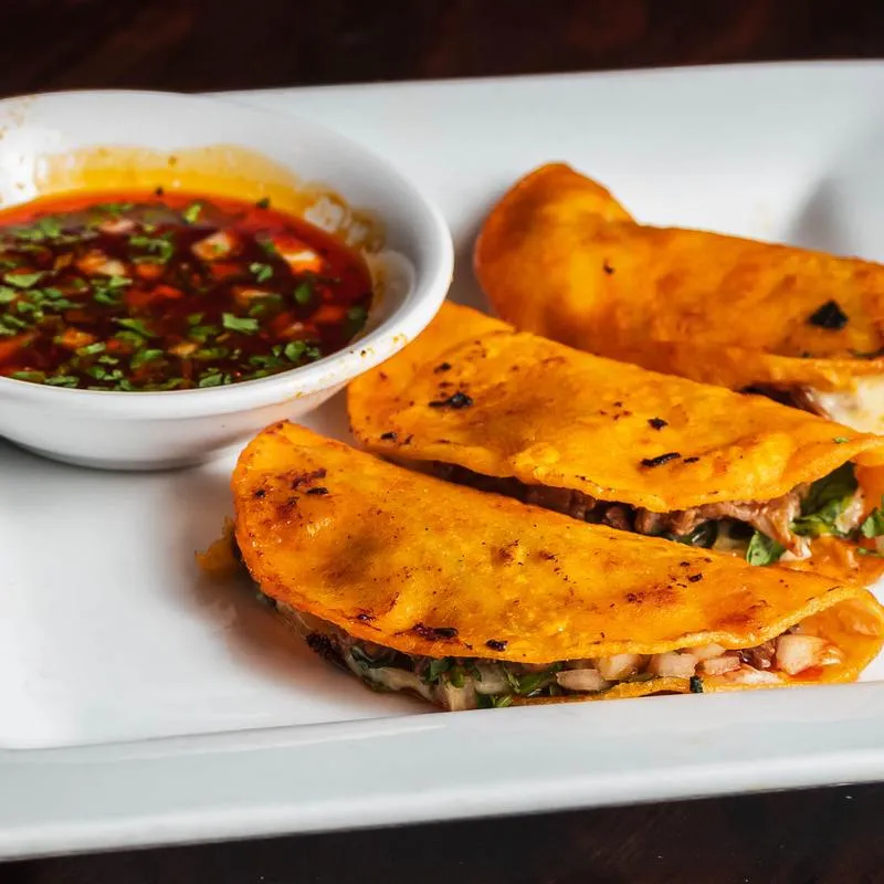 Served Tacos with dip.