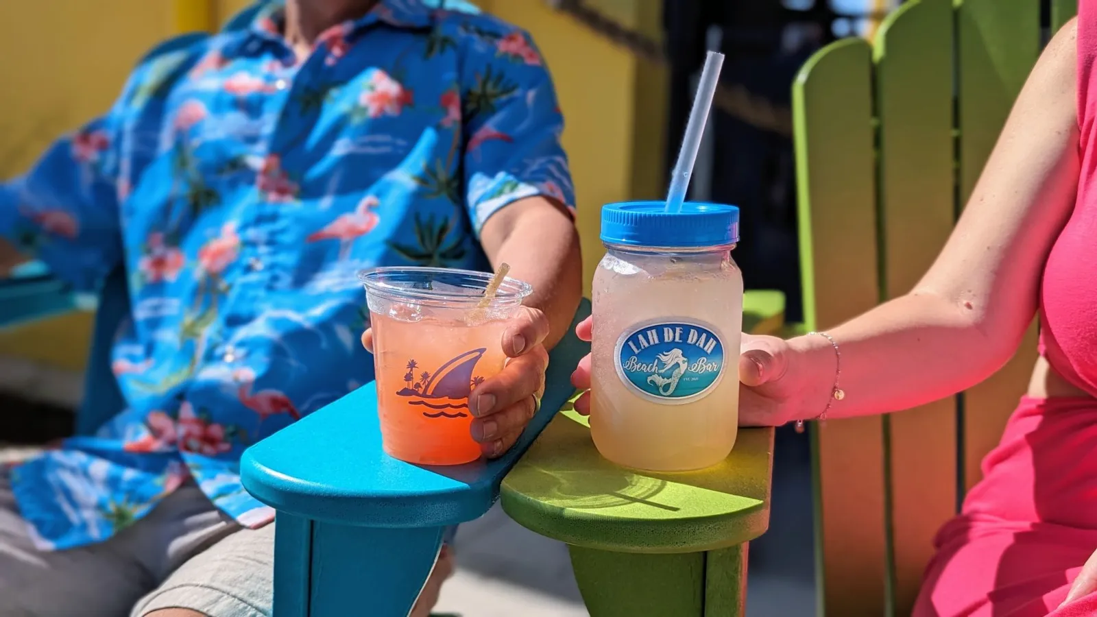 A Couple Of Plastic Cups With Straws And A Straw