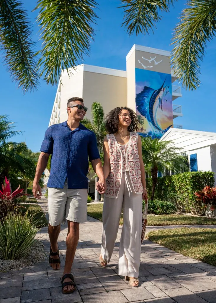 A Man And Woman Posing For A Picture In Front Of A Building