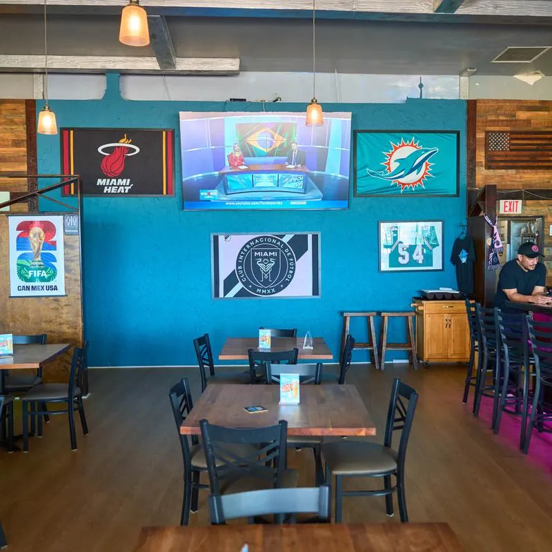 Interior featuring a bright blue accent wall decorated with framed sports memorabilia.