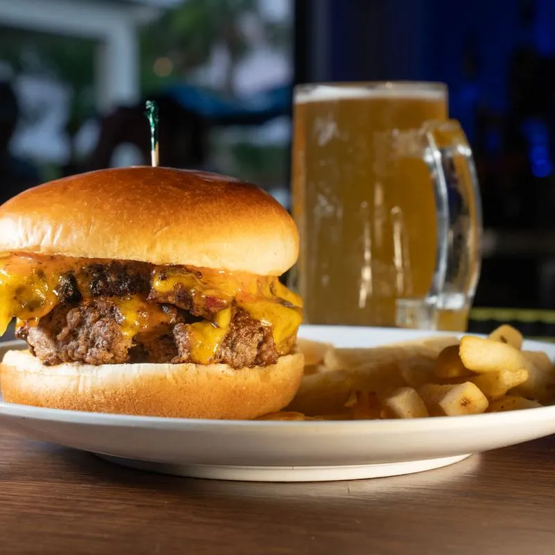Burger topped with shredded brisket, cheddar, and beach sauce.