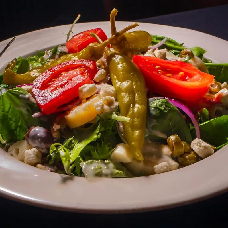 Mediterranean Salad, with mixed greens, heart of palm, onion, olives, artichoke, tomato, and feta.