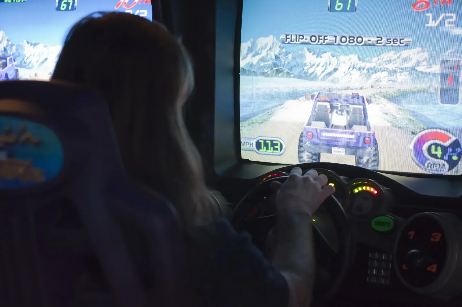 child playing racing arcade game