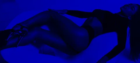 Performer in the blue-lit main room at KAYA Nightclub