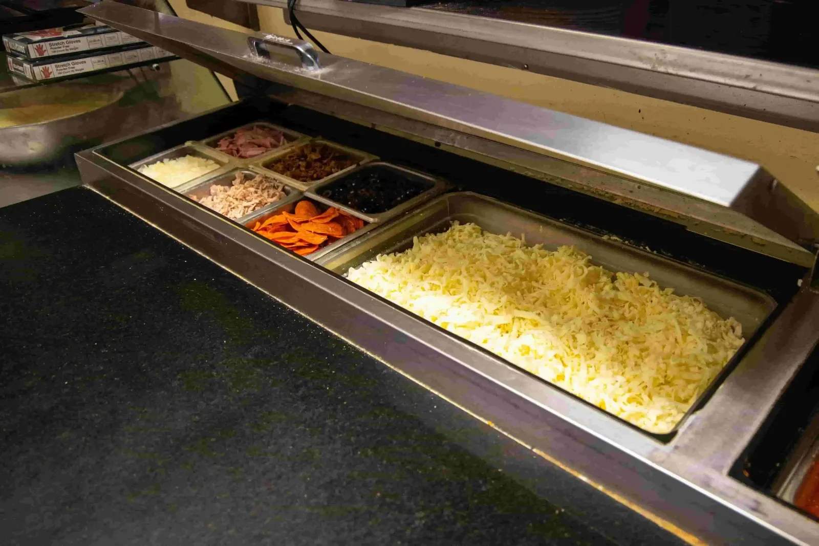 Pizza topping station with cheese and pepperoni