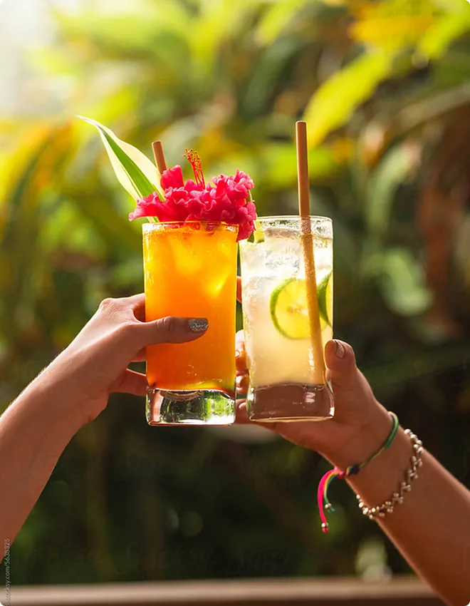 A 'cheers' with two tropical cocktails