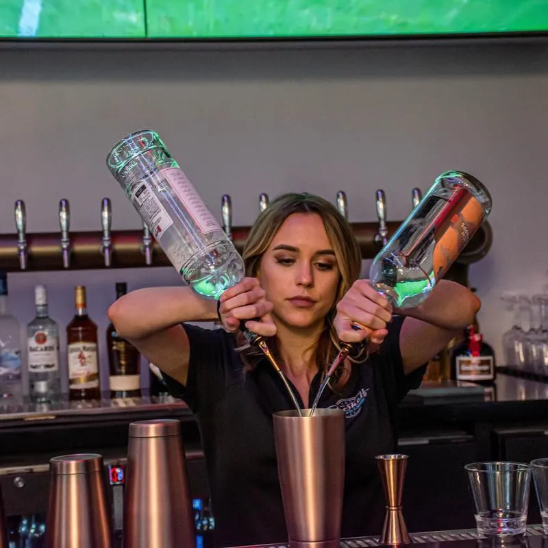 A person mixing a cocktail.