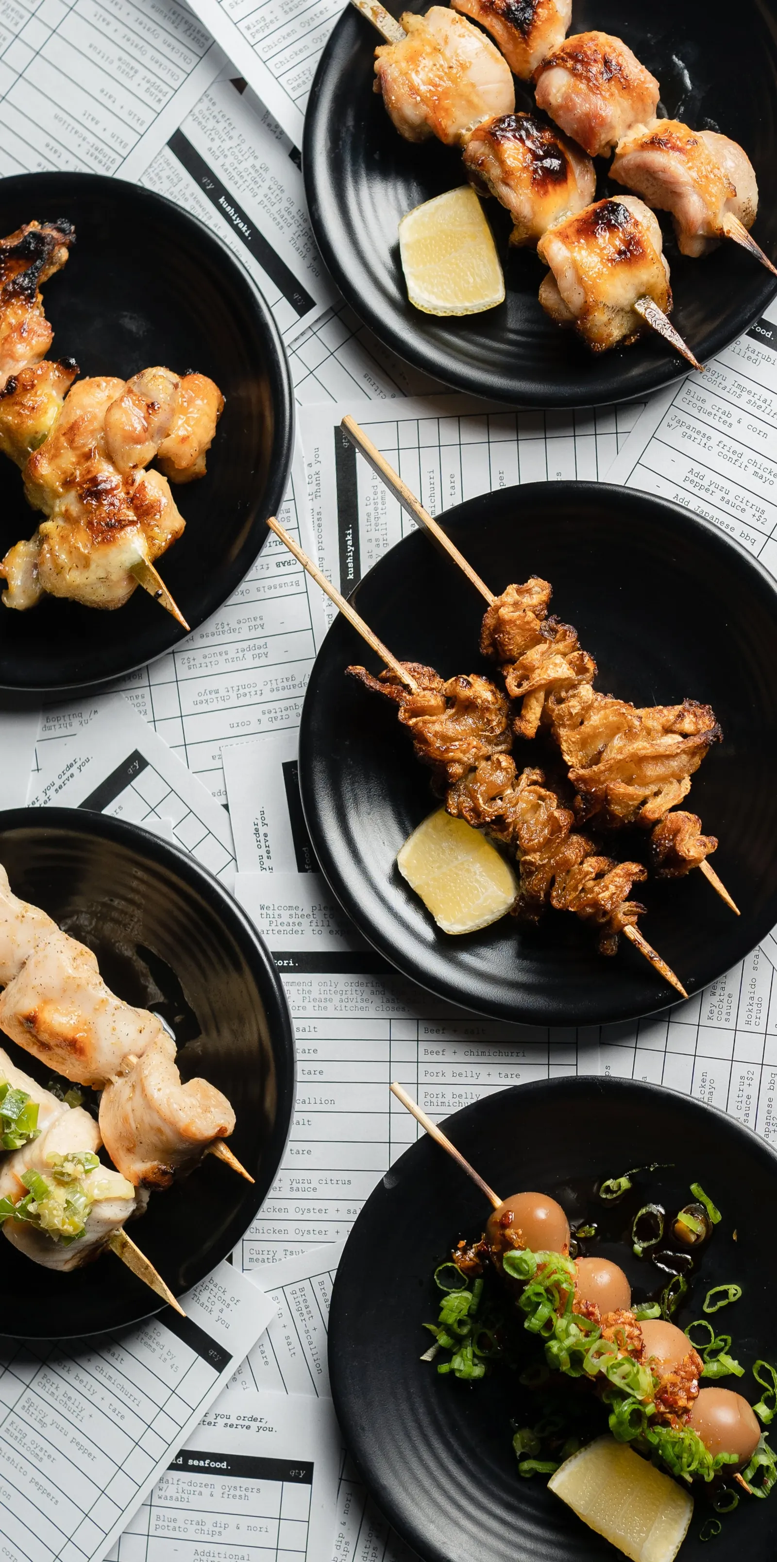 various chicken skewers on a background made of order tickets
