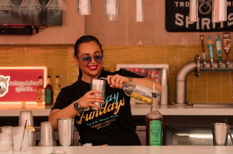 A Person Holding A Glass Of Beer