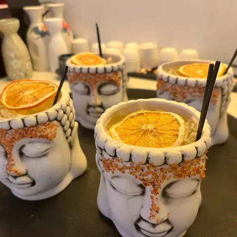 Cocktails in Buddha mugs.