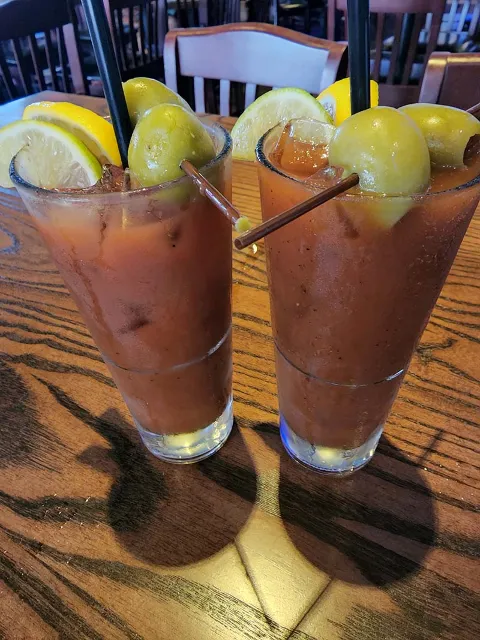 a drink prepared with lemmon and  olives
