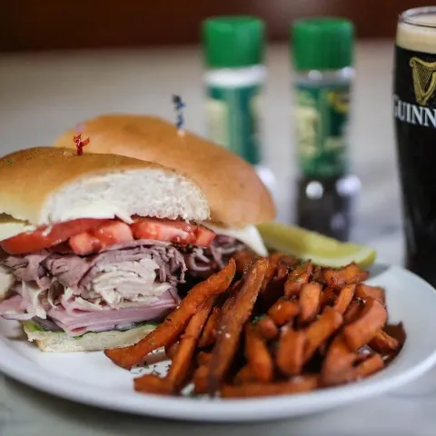 Buffalo Chicken sandwich with fries and Guinness.