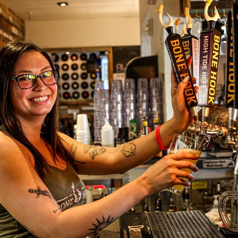 Employee pouring a glass of beer at the tap