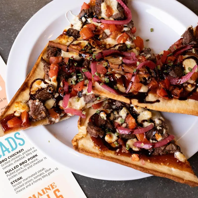 Steak Flatbread slices served on a plate.