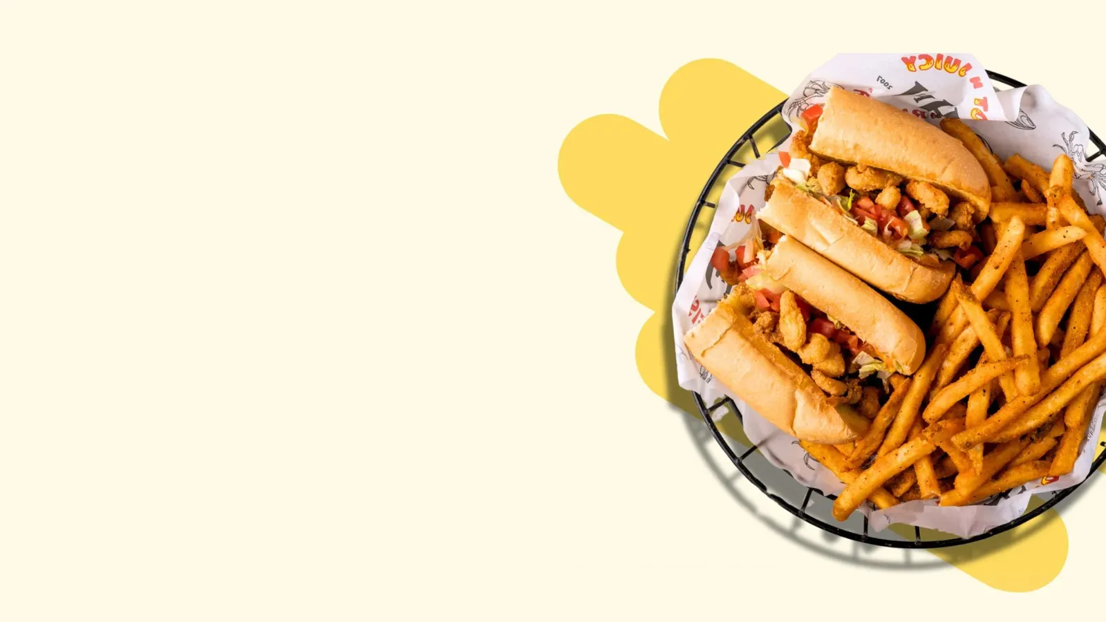 Basket with fried chicken sandwiches and seasoned French fries on paper with restaurant branding.