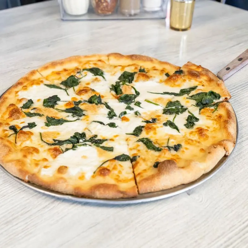 White pizza topped with ricotta, mozzarella and sautéed greens.