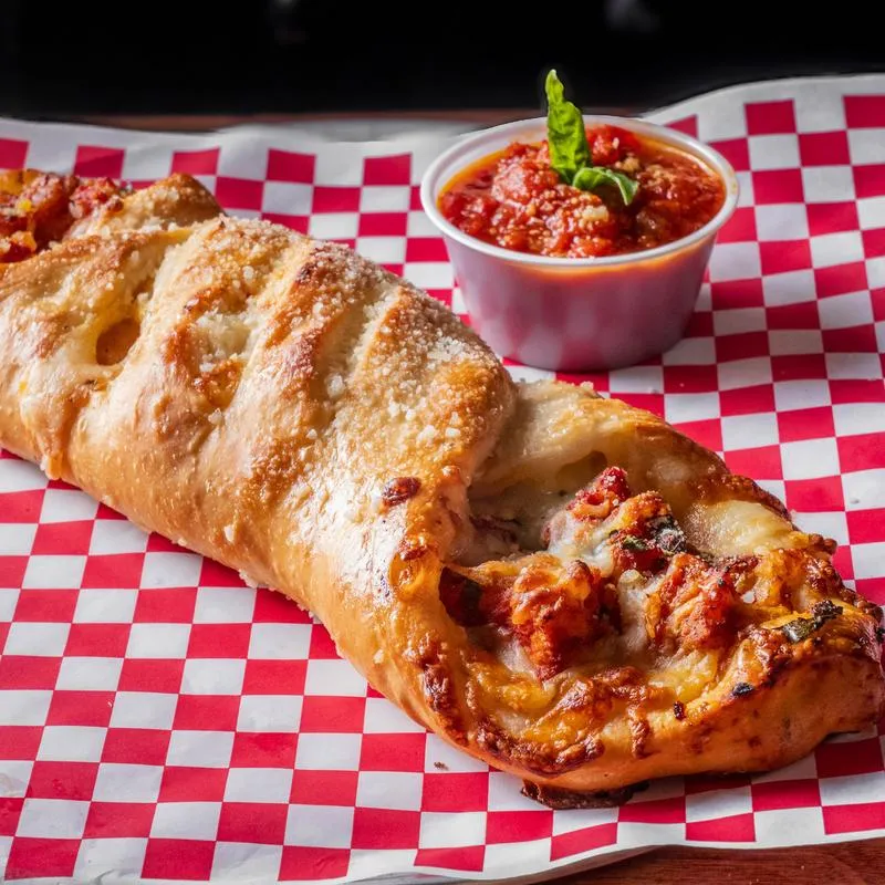 Stromboli served with marinara sauce.