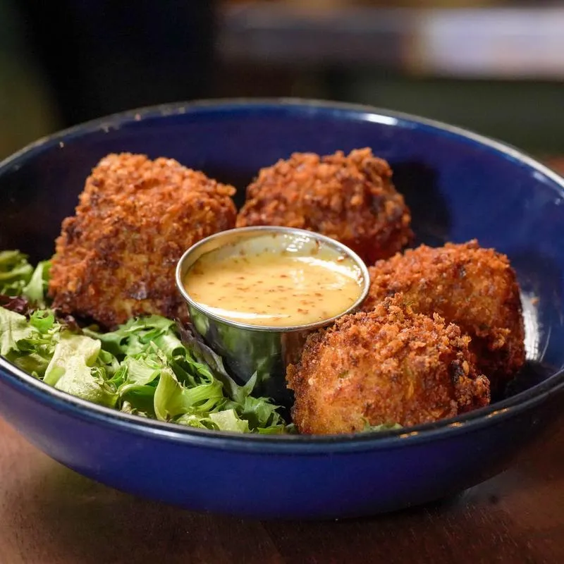 Corned beef fritters with greens and house-made Guinness mustard sauce.