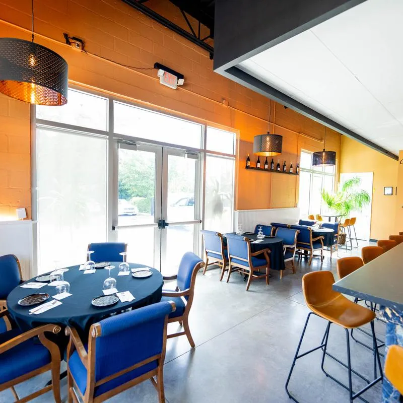 Interior, dining room with place settings on tables.