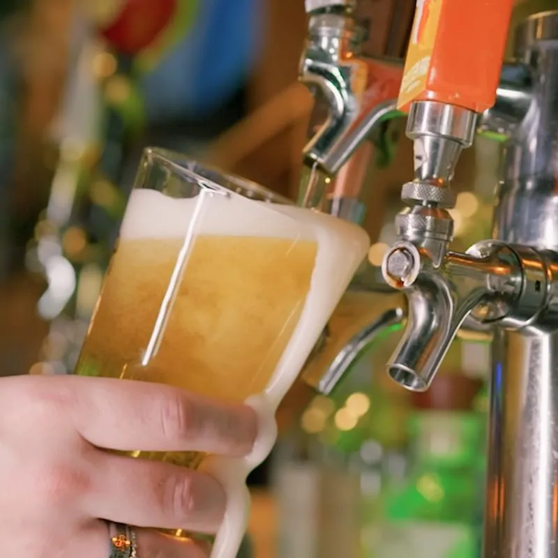 Beer being pured from a tap into a glass.