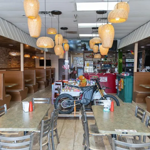 Restaurant dining area with tables and a decorative motorcycle.
