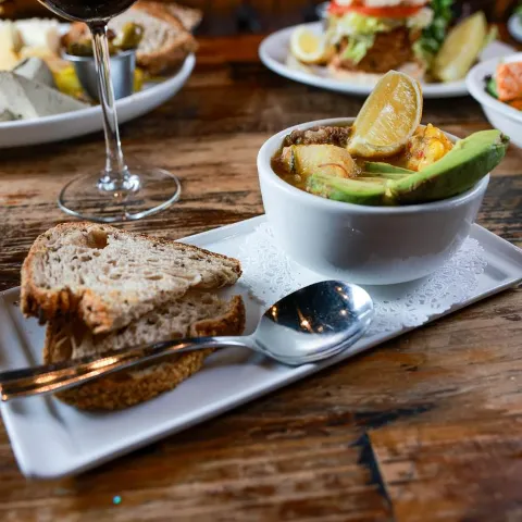 A soup du  jours  on atable with assorted meals