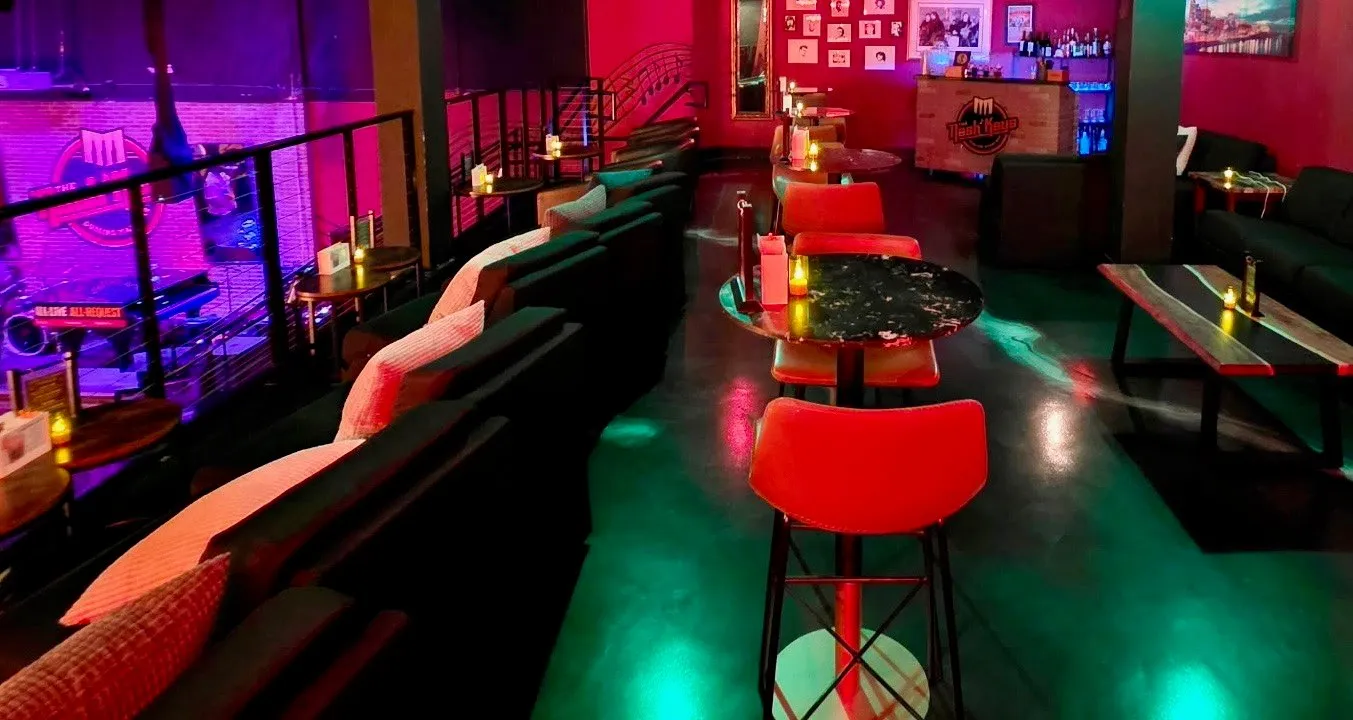 The VIP balcony at The Nash Keys — private bar, lounge seating and a second-floor view over the dueling piano stage