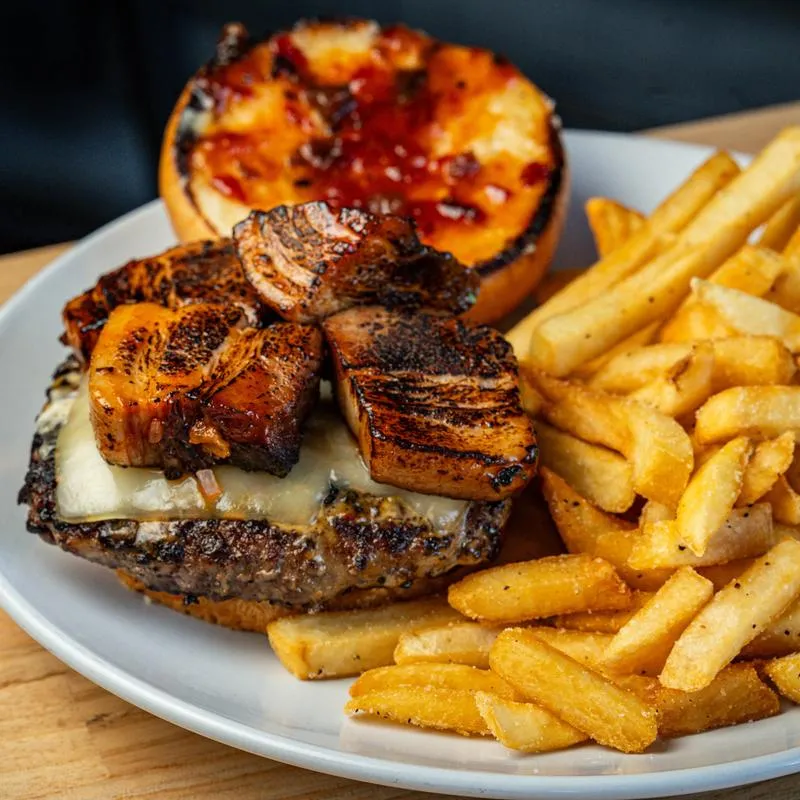 Cheeseburger with pork belly and fries.