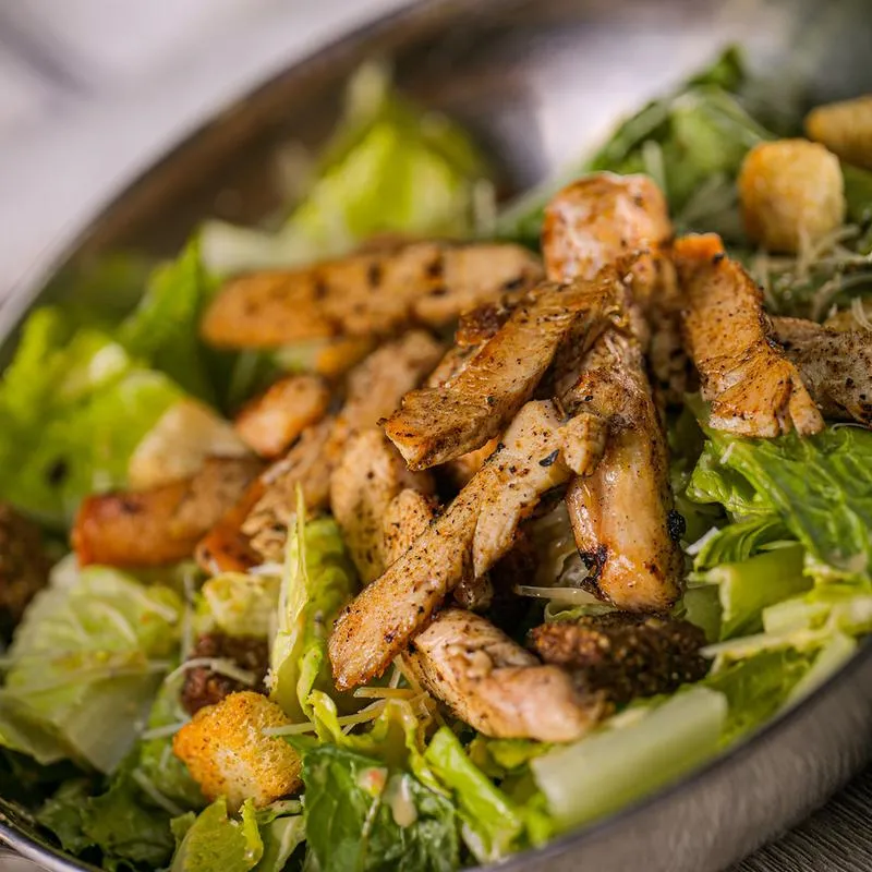 Sliced grilled meat and green salad.