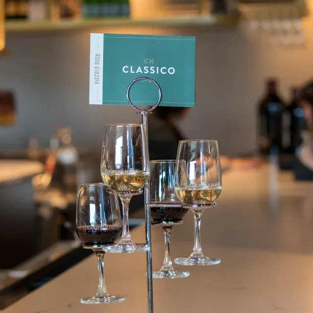 A wine tasting flight with four glasses of wine.