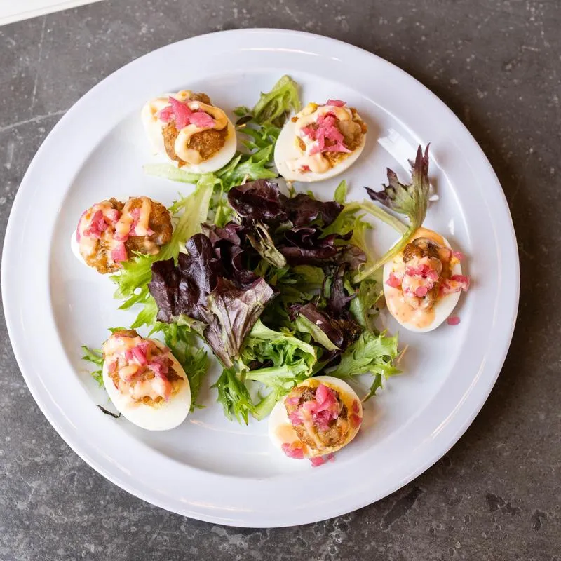 Port Saint John oyster eggs served on greens.