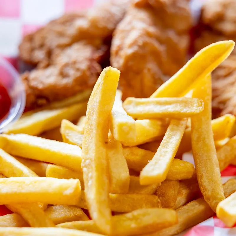 Close up of French fries and chicken tenders.