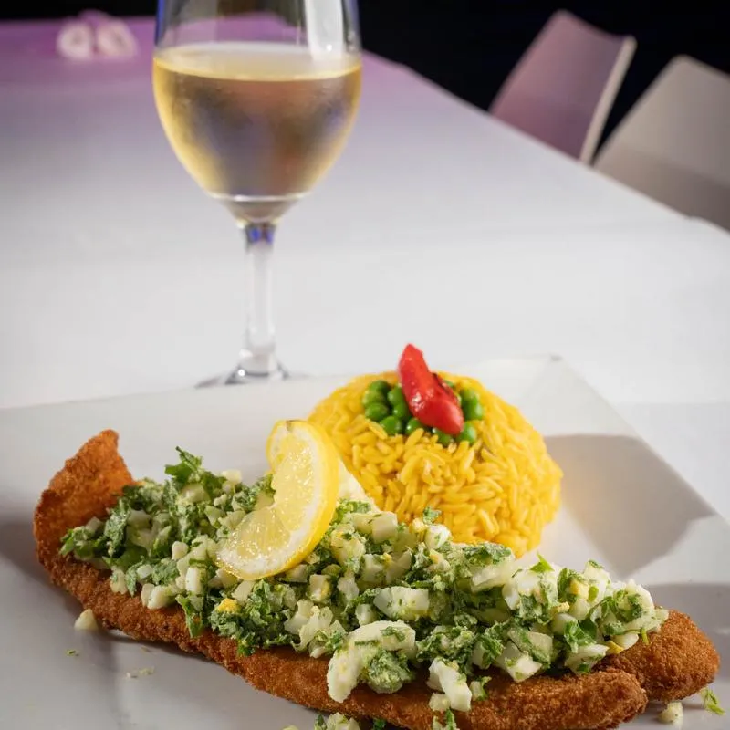 Chicken Milanese with a glass of white wine.