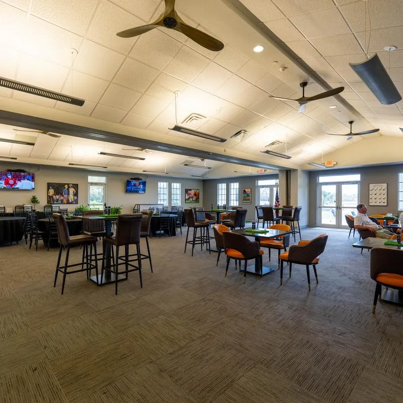 Dining area with various seating options including high-top tables and lounge chairs.