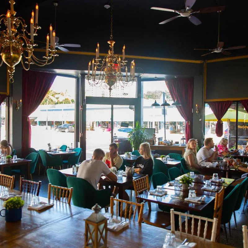 Interior, guests dining, set tables waiting for new guests, chandeliers