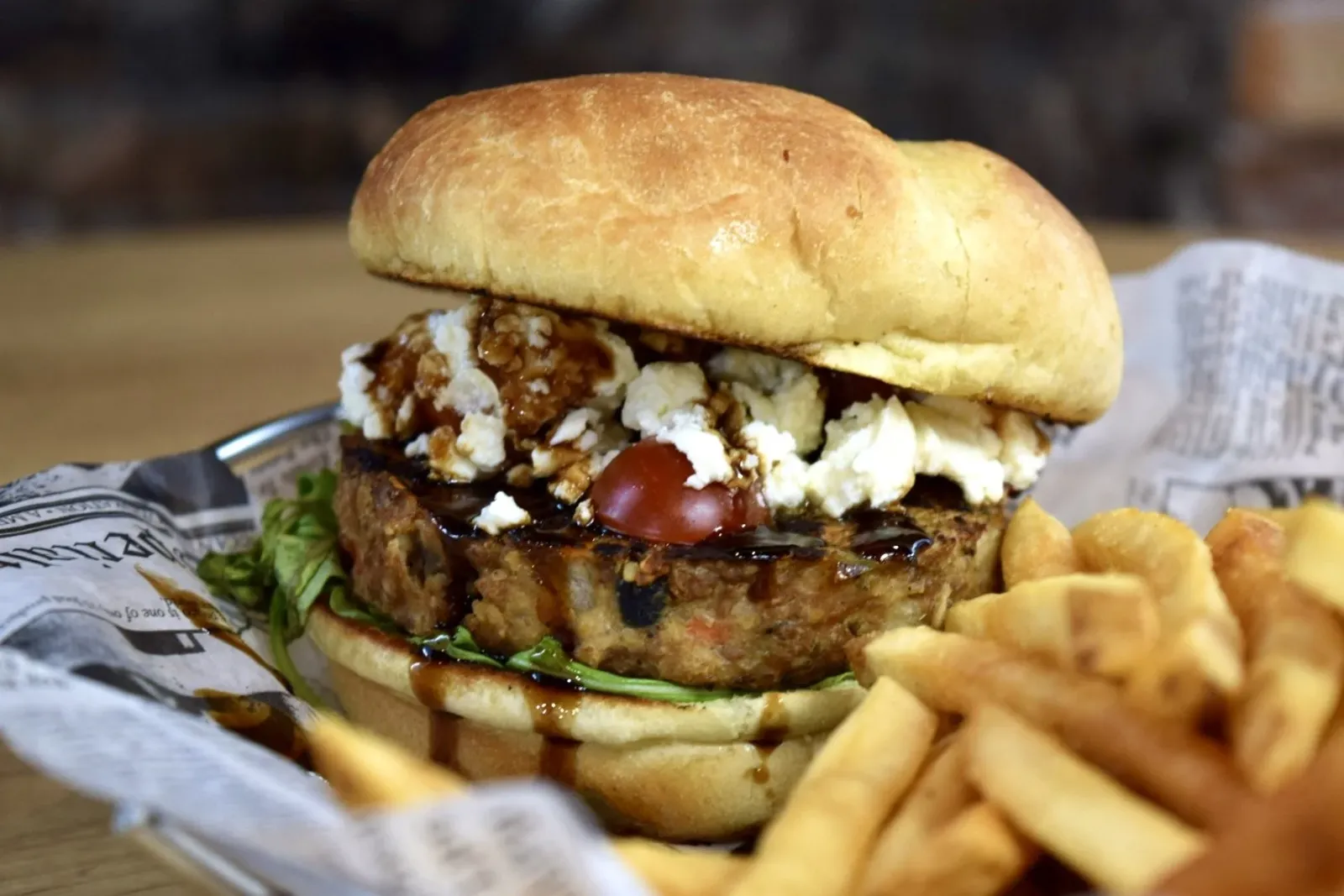 Close-up of a cheeseburger with a side of French fries.