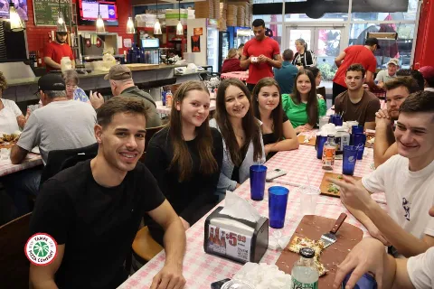 groups of people eating pizza at tampa pizza company