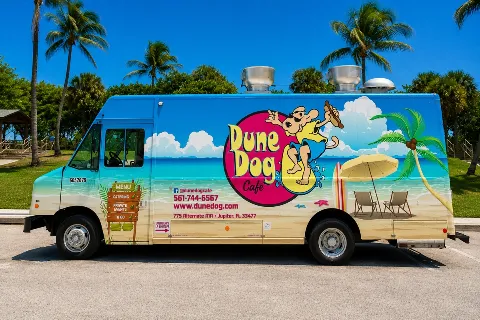 The Dune Dog Cafe food truck parked by palm trees